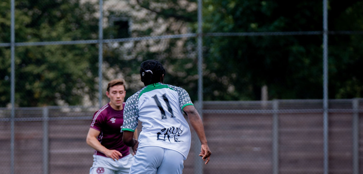 Newteam FC number 11 seen from behind, turning away during a match